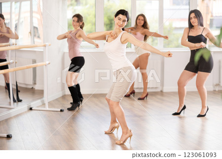 Young woman performing sass dance during group class Young woman performing sass dance during group class 123061093