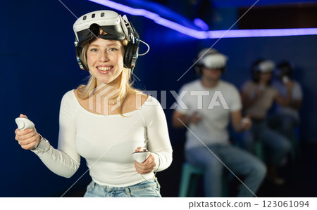 Girl in virtual reality glasses is playing a video game 123061094