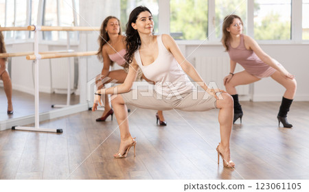Girls in heels learn to move to beat of music and combine rhythm and smooth movements 123061105