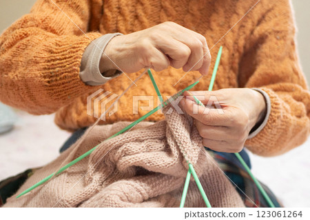 Person knitting a ball of yarn Person knitting a ball of yarn 123061264