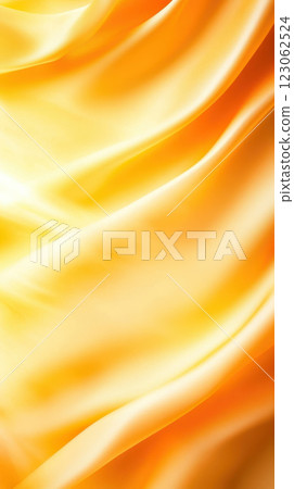Silky yellow fabric with soft waves and gentle folds creates warm ambiance Silky yellow fabric with soft waves and gentle folds creates warm ambiance 123062524