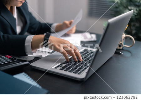 Finance bank tax expense accounting budget money businessman hand use calculator Financial calculate accountant close up calculator with graph chart write office desk Business expense analysis saving 123062782