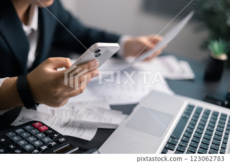 Finance bank tax expense accounting budget money businessman hand use calculator Financial calculate accountant close up calculator with graph chart write office desk Business expense analysis saving 123062783