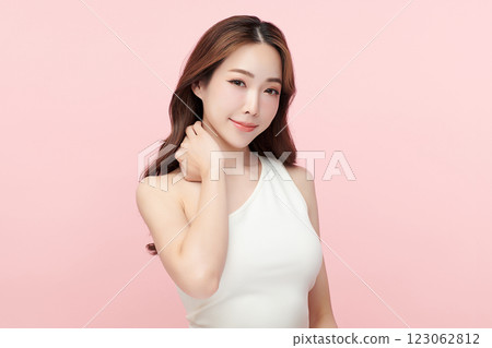 Beautiful young asian woman with clean fresh skin on pink background, Face care, Facial treatment, Cosmetology, beauty and spa, Asian women portrait. Beautiful young asian woman with clean fresh skin on pink background, Face care, Facial treatment, Cosmetology, beauty and spa, Asian women portrait. 123062812