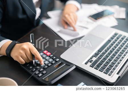 Finance bank tax expense accounting budget money businessman hand use calculator Financial calculate accountant close up calculator with graph chart write office desk Business expense analysis saving Finance bank tax expense accounting budget money businessman hand use calculator Financial calculate accountant close up calculator with graph chart write office desk Business expense analysis saving 123063265