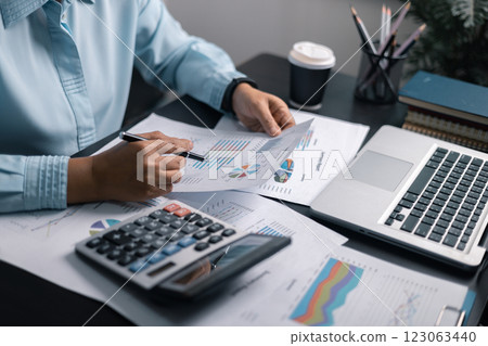 Finance bank tax expense accounting budget money businessman hand use calculator Financial calculate accountant close up calculator with graph chart write office desk Business expense analysis saving Finance bank tax expense accounting budget money businessman hand use calculator Financial calculate accountant close up calculator with graph chart write office desk Business expense analysis saving 123063440