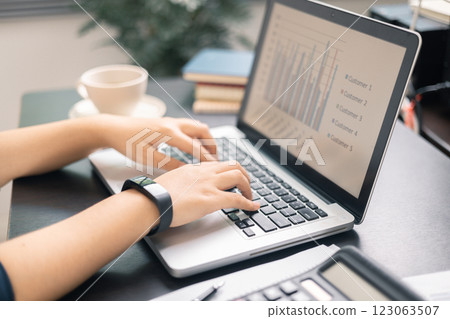 Finance bank tax expense accounting budget money businessman hand use calculator Financial calculate accountant close up calculator with graph chart write office desk Business expense analysis saving 123063507