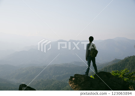 Man traveler with camera backpack hiking outdoor travel lifestyle and adventure concept. cap backpack and join of tourist for green mountain tour, beauty of nature and expansive sky people of tourism 123063894
