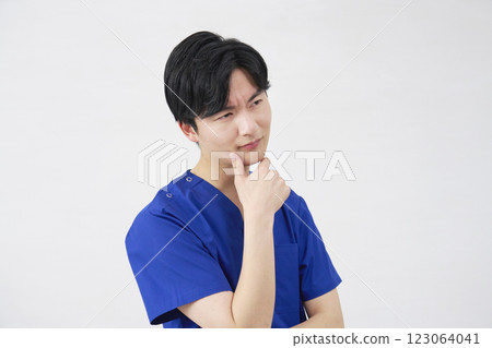 Doctor, nurse, dentist, caregiver, male, worried, white background Doctor, nurse, dentist, caregiver, male, worried, white background 123064041