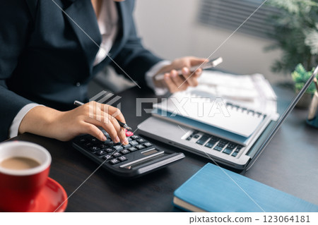 Finance bank tax expense accounting budget money businessman hand use calculator Financial calculate accountant close up calculator with graph chart write office desk Business expense analysis saving Finance bank tax expense accounting budget money businessman hand use calculator Financial calculate accountant close up calculator with graph chart write office desk Business expense analysis saving 123064181