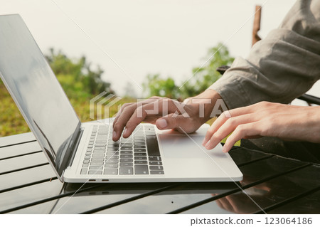 Young business man working computer on peak hill. Hiker online shopping on laptop at sunset, sunrise on top mountain, freelance person remote work with digital tablet. travel vacation holiday concept Young business man working computer on peak hill. Hiker online shopping on laptop at sunset, sunrise on top mountain, freelance person remote work with digital tablet. travel vacation holiday concept 123064186