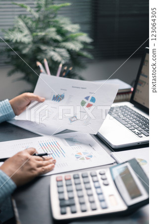 Finance bank tax expense accounting budget money businessman hand use calculator Financial calculate accountant close up calculator with graph chart write office desk Business expense analysis saving 123064305