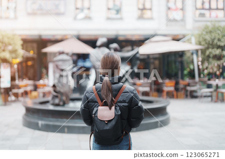 woman traveler visiting in Shanghai, China. Female Tourist with backpack sightseeing in Xintiandi. landmark and popular for tourism attractions in Shanghai. Travel and vacation concept 123065271