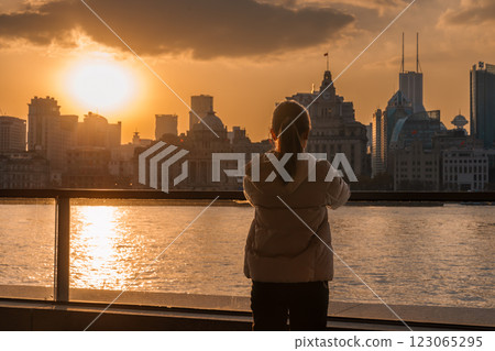 woman traveler visiting in Shanghai, China. Happy Female Tourist sightseeing Shanghai view of the bund in Lujiazui at sunset. landmark and popular for tourism attractions. Travel and Vacation concept 123065295