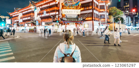 woman traveler visiting in Shanghai, China. Happy Female Tourist sightseeing and shopping in Yuyuan Old Street market at night. landmark and popular for tourism attractions. Travel and Vacation woman traveler visiting in Shanghai, China. Happy Female Tourist sightseeing and shopping in Yuyuan Old Street market at night. landmark and popular for tourism attractions. Travel and Vacation 123065297
