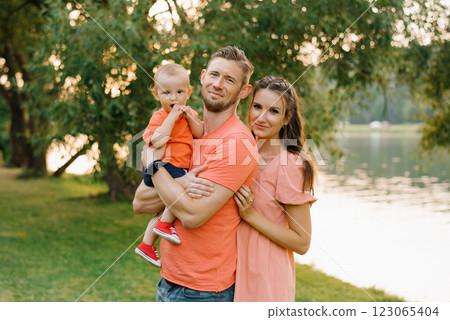 Joyful Family Posing Near Lake 123065404