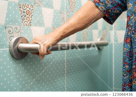 Asian elderly woman patient use toilet bathroom handle security in nursing hospital, healthy strong medical. 123066436