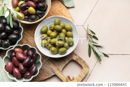 Green, black and kalamata olives displayed on wooden board 123066641