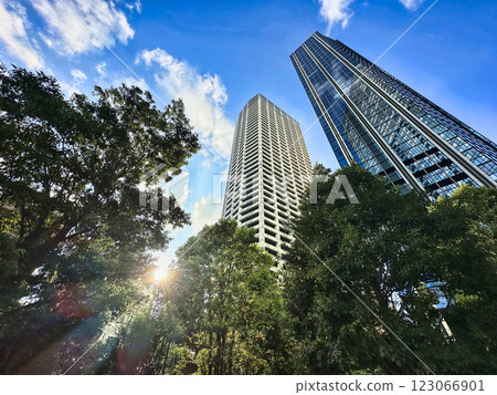 Urban high-rise apartment building with blue sky and white clouds, daytime 123066901