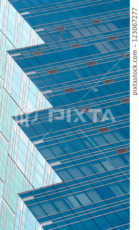 Another modern glass building with a unique stepped design, showcasing contemporary architecture and reflective surfaces. Another modern glass building with a unique stepped design, showcasing contemporary architecture and reflective surfaces. 123067277