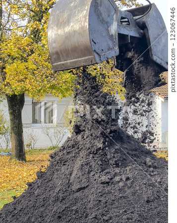 France, Gironde, December 2024, Delivery of topsoil by truck crane to the garden of a residential France, Gironde, December 2024, Delivery of topsoil by truck crane to the garden of a residential 123067446