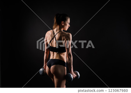 Back view of female model posing in studio and demonstrating comfortable activewear. Back view of female model posing in studio and demonstrating comfortable activewear. 123067980
