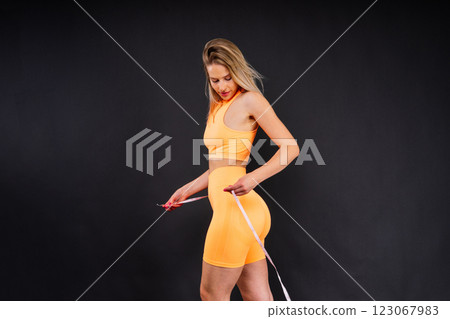 Fitness and sport concept. Portrait of smiling young woman wearing sportswear posing isolated 123067983