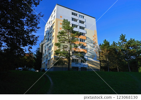 Original prefabricated houses on a housing estate from the communist era in Eastern and Central Europe after reconstruction.. Facade of a modern apartment building with windows and balconies. Czech 123068130
