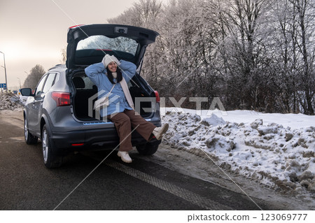 Woman Relaxing in Car on Snowy Road Woman Relaxing in Car on Snowy Road 123069777