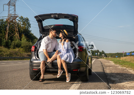 Couple Enjoying a Sunny Day by the Car 123069782