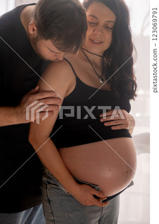 Intimate Moment of Expecting Parents by the Window Intimate Moment of Expecting Parents by the Window 123069791