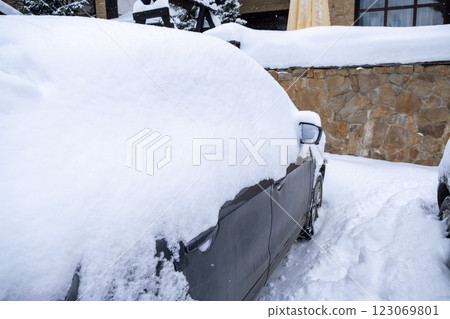 Person Clearing Snow from Car in Winter Landscape Person Clearing Snow from Car in Winter Landscape 123069801