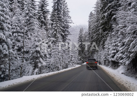 Car on Snowy Mountain Road 123069802