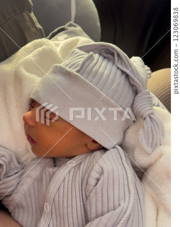 Newborn Baby Sleeping in Cozy Gray Outfit Newborn Baby Sleeping in Cozy Gray Outfit 123069838