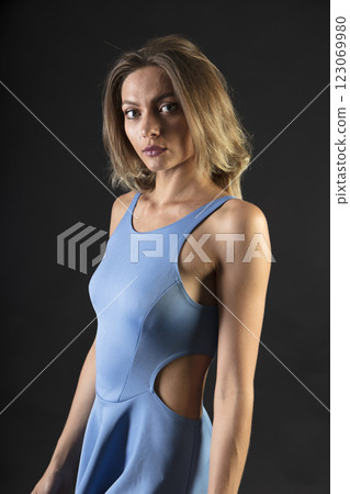 portrait of a young beautiful woman on a dark background 123069980