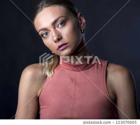portrait of a young beautiful woman on a dark background portrait of a young beautiful woman on a dark background 123070005
