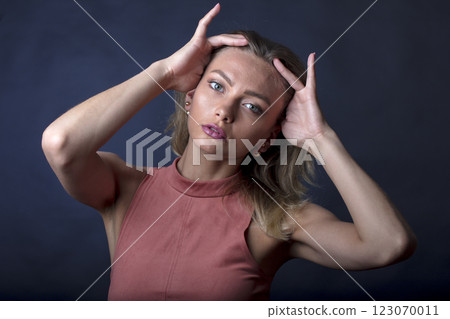 portrait of a young beautiful woman on a dark background portrait of a young beautiful woman on a dark background 123070011