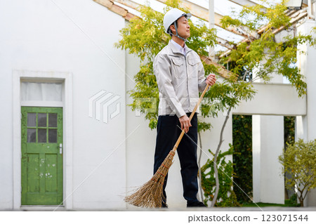 A man wearing cleaning clothes A man wearing cleaning clothes 123071544