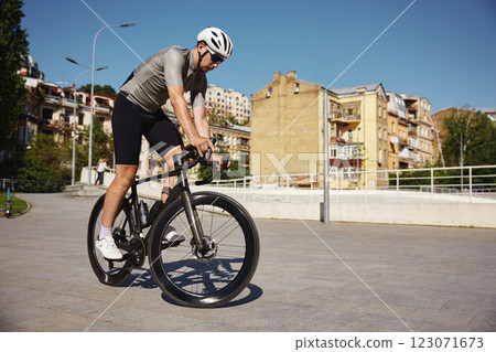 Cyclist in activewear and protective headgear came to velodrome for training 123071673