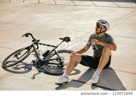 Sportsman resting enjoying refreshing time during cycling training Sportsman resting enjoying refreshing time during cycling training 123071694