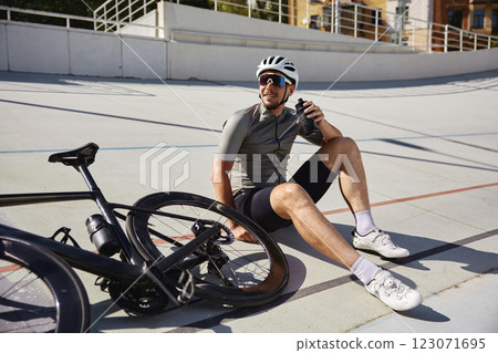 Happy tired sportsman resting enjoying refreshing time during cycling training 123071695