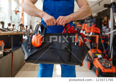 Cropped shot of repairman or construction worker carrying toolbox handbag 123071766