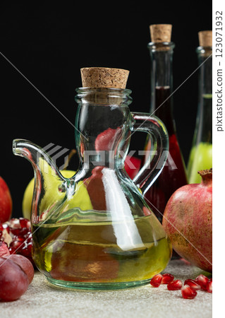 Vinegar in a glass vinegar bowl with a spout on a black background. Vinegar in a glass vinegar bowl with a spout on a black background. 123071932
