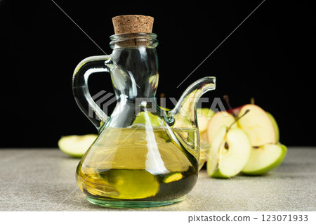 Apple cider vinegar in a glass vinegar bowl among apples 123071933
