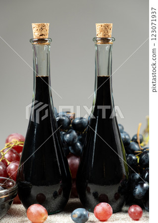 Balsamic vinegar in bottles among grapes 123071937