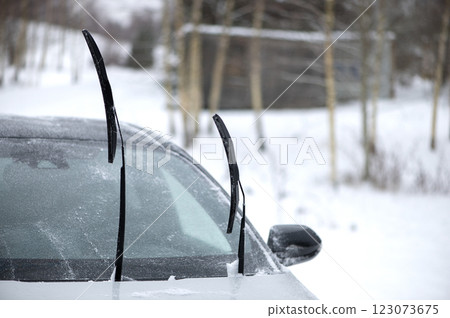 Windshield wiper raised up and icy car windshield. Leave Windshield Wipers Up in the Ice and Snow 123073675