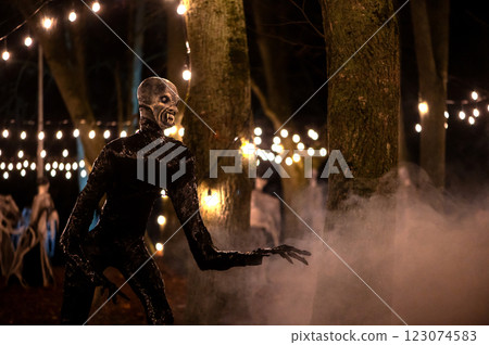 Spooky Halloween decoration stands in a wooded area creating a sinister atmosphere 123074583