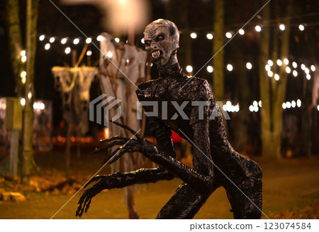 Spooky Halloween decoration stands in a wooded area creating a sinister atmosphere Spooky Halloween decoration stands in a wooded area creating a sinister atmosphere 123074584