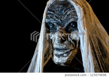 Close-up of witch face on a dark halloween horror night background 123074696