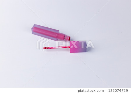 Stylish Pink Lip Gloss Bottle with Applicator on a Clean Surface Perfect for Beauty Enthusiasts and Makeup Lovers Looking to Add a Pop of Color to Their Look Stylish Pink Lip Gloss Bottle with Applicator on a Clean Surface Perfect for Beauty Enthusiasts and Makeup Lovers Looking to Add a Pop of Color to Their Look 123074729